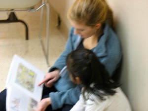Adelaide and Meliza curl up with a book - IPC STAIR literacy program
